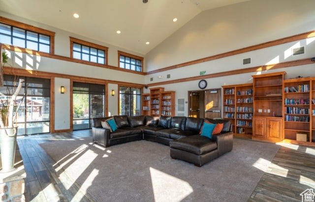 living area featuring visible vents, recessed lighting, high vaulted ceiling, and wood finished floors