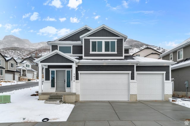view of front of house featuring central air condition unit, a mountain view, and a garage