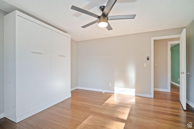 151 S Bernice Way N, Salt Lake, UT 84054 - unfurnished bedroom featuring light wood-style flooring, baseboards, and a ceiling fan