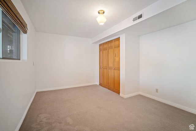 151 S Bernice Way N, Salt Lake, UT 84054 - unfurnished bedroom with light colored carpet, baseboards, and a closet