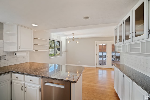 151 S Bernice Way, North Salt Lake, UT 84054 - kitchen featuring white cabinetry, dark stone counters, decorative backsplash, kitchen peninsula, and light wood-type flooring