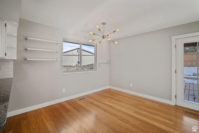 151 S Bernice Way N, Salt Lake, UT 84054 - spare room featuring a chandelier, wood finished floors, and baseboards
