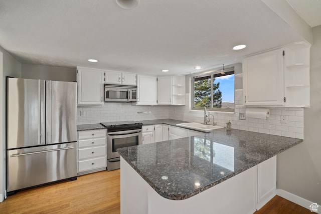 151 S Bernice Way, North Salt Lake, UT 84054 - kitchen featuring kitchen peninsula, sink, light hardwood / wood-style flooring, appliances with stainless steel finishes, and white cabinets