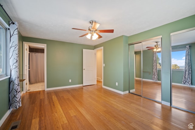 151 S Bernice Way, North Salt Lake, UT 84054 - unfurnished bedroom featuring ceiling fan, hardwood / wood-style floors, and multiple closets