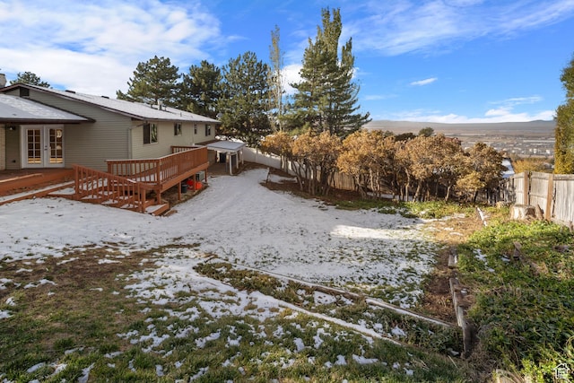 151 S Bernice Way N, Salt Lake, UT 84054 - snowy yard with french doors, a deck, and a fenced backyard