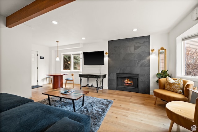 1492 W Meadow Loop Rd Unit 21/22, Snyderville, UT 84098 - living room featuring beam ceiling, light wood-type flooring, and a tiled fireplace