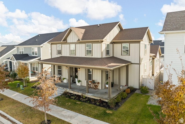 6443 W Early Bird Dr, South Jordan, UT 84009 - rear view of property featuring board and batten siding, covered porch, a yard, and a shingled roof