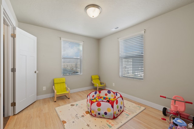 6443 W Early Bird Dr, South Jordan, UT 84009 - recreation room featuring wood finished floors and baseboards