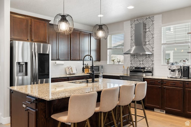 6443 W Early Bird Dr, South Jordan, UT 84009 - kitchen featuring stainless steel appliances, wall chimney exhaust hood, a sink, decorative backsplash, and recessed lighting