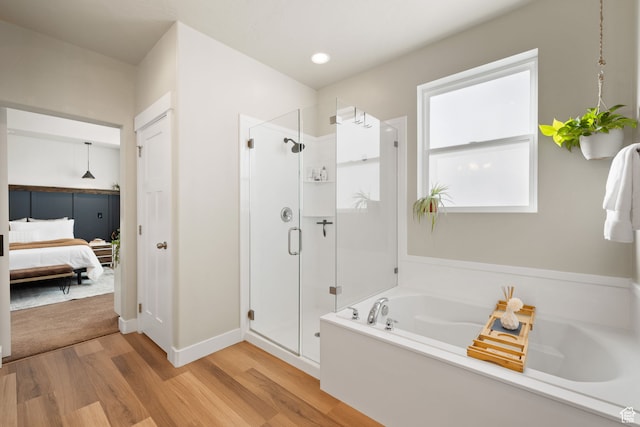 6443 W Early Bird Dr, South Jordan, UT 84009 - full bath featuring wood finished floors, a garden tub, a stall shower, and connected bathroom