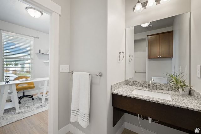 6443 W Early Bird Dr, South Jordan, UT 84009 - bathroom featuring a sink, baseboards, and wood finished floors