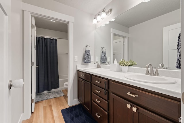 6443 W Early Bird Dr, South Jordan, UT 84009 - full bathroom with wood finished floors, double vanity, toilet, and shower / bath combo