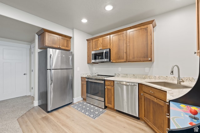 6443 W Early Bird Dr, South Jordan, UT 84009 - kitchen with stainless steel appliances, a sink, light wood-style floors, light stone counters, and recessed lighting