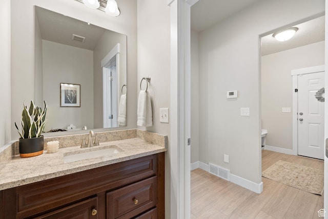 6443 W Early Bird Dr, South Jordan, UT 84009 - bathroom with wood finished floors, vanity, and baseboards