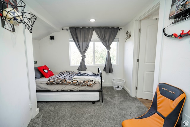 carpeted bedroom with lofted ceiling