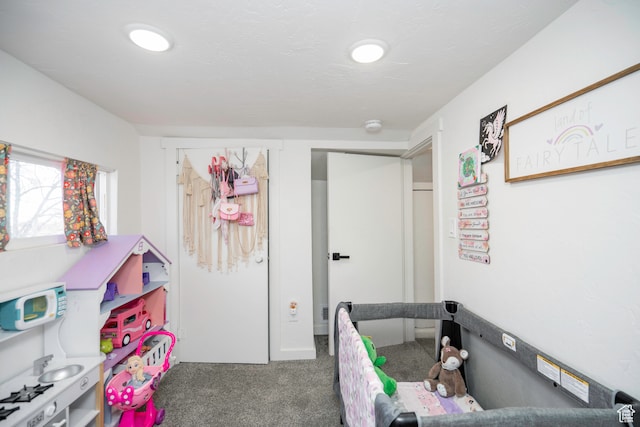recreation room featuring dark colored carpet