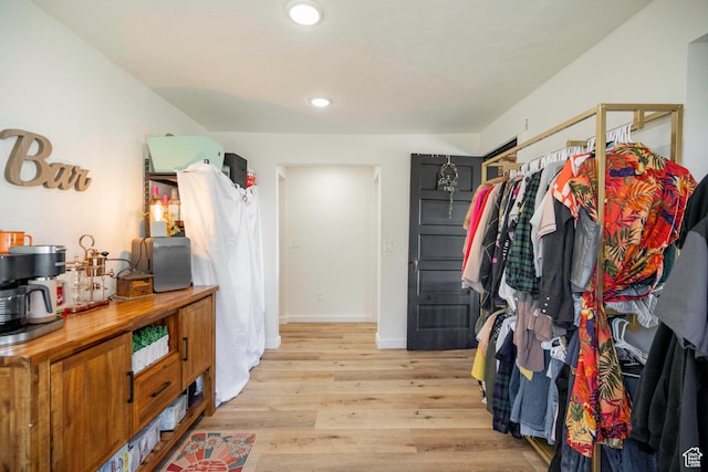 walk in closet with light wood-type flooring