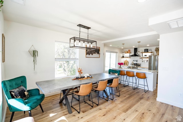 dining space featuring light hardwood / wood-style flooring and sink