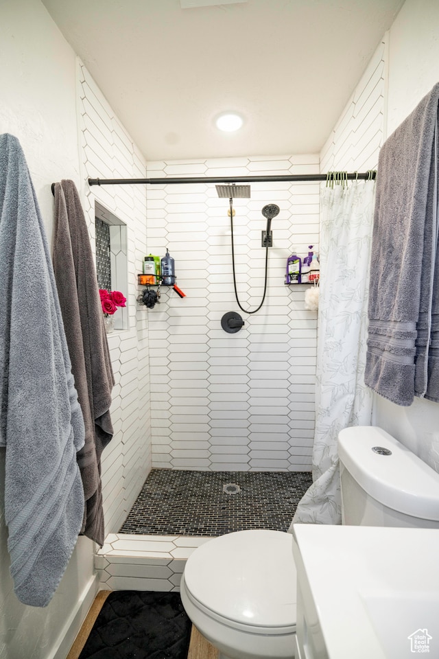 bathroom with walk in shower and toilet