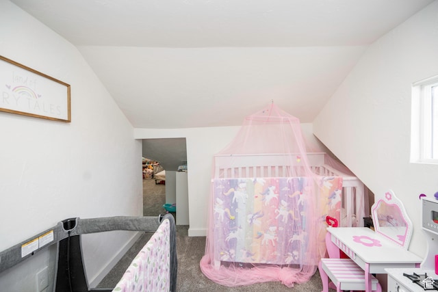 bedroom with carpet flooring and lofted ceiling