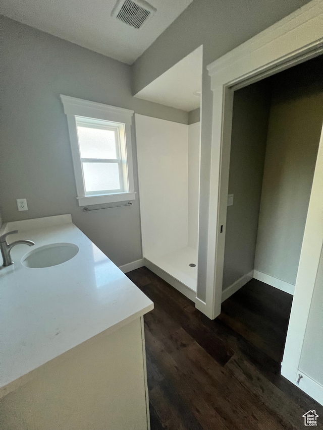 437 S 580 W, Providence, UT 84332 - bathroom with hardwood / wood-style flooring, vanity, and walk in shower