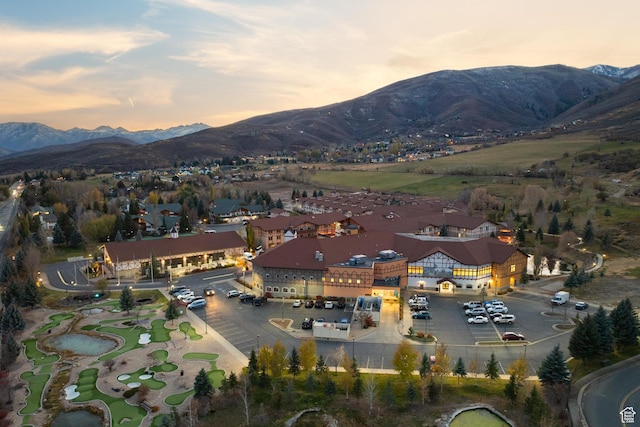 aerial view at dusk featuring a mountain view