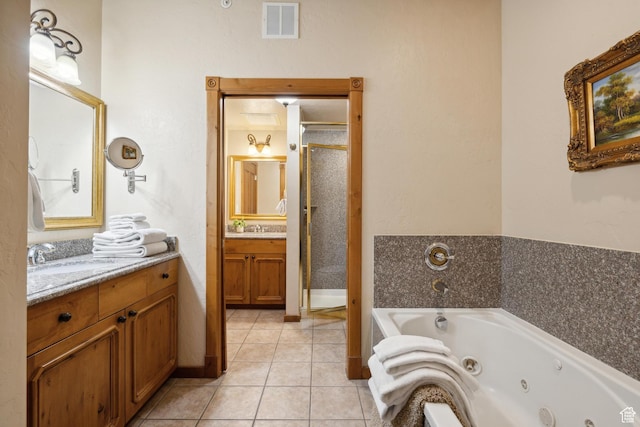 bathroom with tile patterned floors, vanity, and shower with separate bathtub