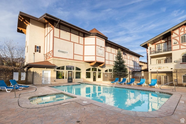 view of pool featuring a patio area and a community hot tub