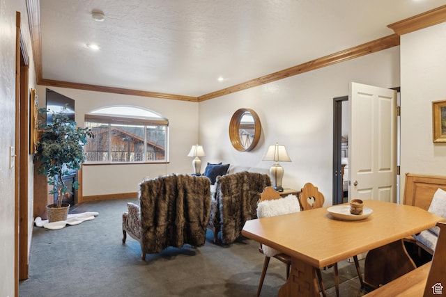carpeted dining room with ornamental molding and a textured ceiling