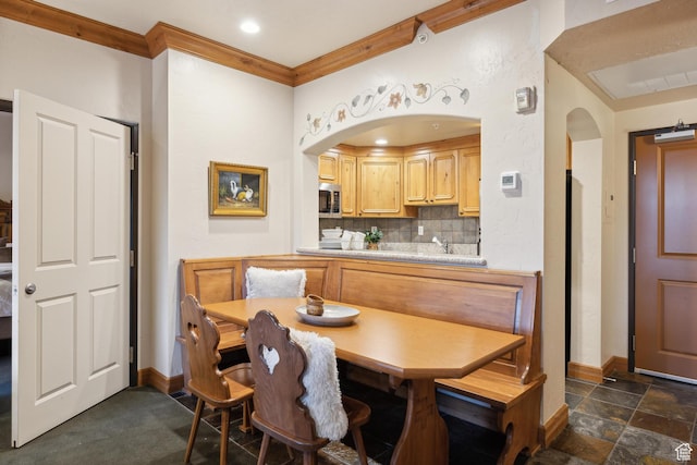 dining space with crown molding