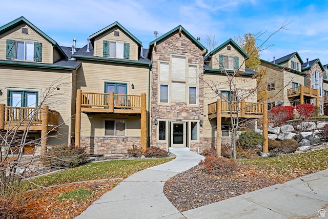 3521 N Fox Run Unit 811, Eden, UT 84310 - view of front of house with stone siding, a balcony, and a residential view