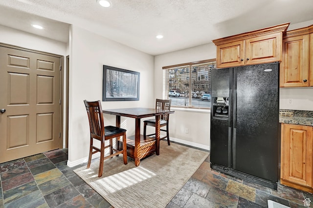 3521 N Fox Run Unit 811, Eden, UT 84310 - kitchen featuring black fridge with ice dispenser, stone tile flooring, baseboards, recessed lighting, and a textured ceiling