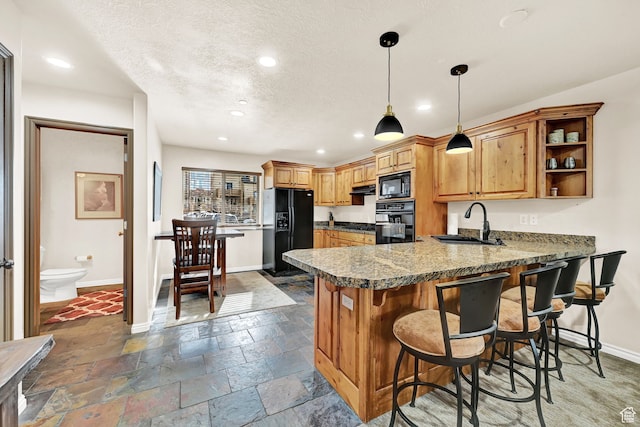 3521 N Fox Run Unit 811, Eden, UT 84310 - kitchen with black appliances, a sink, a peninsula, baseboards, and recessed lighting