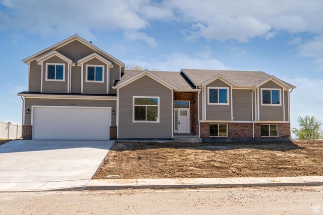 1342 N 4075 W Unit 3A, Vernal, UT 84078 - view of front of home featuring brick siding, a garage, and driveway