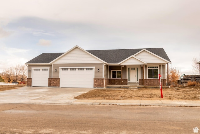 1462 N 4075 W Unit 2, Vernal, UT 84078 - view of front facade with a garage, brick siding, concrete driveway, covered porch, and roof with shingles
