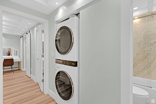4325 S Park St E, Murray, UT 84107 - laundry area with stacked washing maching and dryer and light hardwood / wood-style flooring