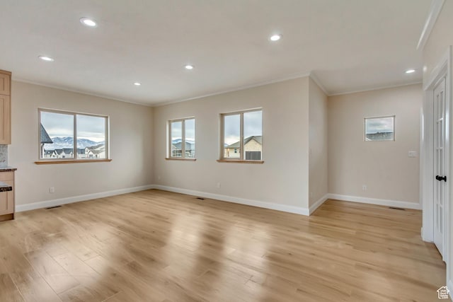 408 Rigdon St, Grantsville, UT 84029 - unfurnished living room with crown molding, light wood-style floors, baseboards, and recessed lighting