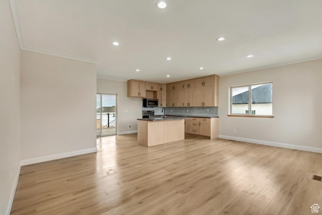 408 Rigdon St, Grantsville, UT 84029 - kitchen featuring appliances with stainless steel finishes, crown molding, open floor plan, a kitchen island with sink, and baseboards