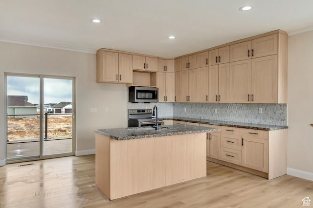 408 Rigdon St, Grantsville, UT 84029 - kitchen with stainless steel appliances, light brown cabinetry, dark stone counters, baseboards, and crown molding
