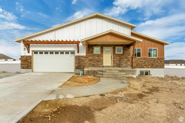 408 Rigdon St, Grantsville, UT 84029 - view of front of home featuring stone siding, board and batten siding, driveway, and a garage