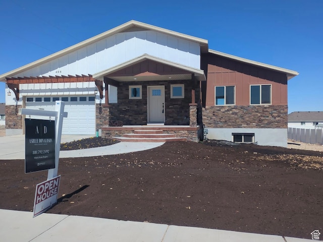 408 Rigdon St, Grantsville, UT 84029 - view of front of house featuring stone siding, board and batten siding, a garage, and concrete driveway