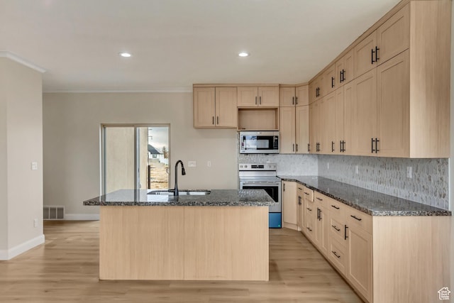 408 Rigdon St, Grantsville, UT 84029 - kitchen featuring stainless steel appliances, a sink, light brown cabinetry, dark stone counters, and decorative backsplash