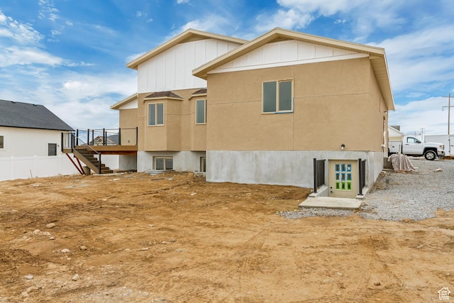 408 Rigdon St, Grantsville, UT 84029 - rear view of house with stairway, board and batten siding, and a wooden deck