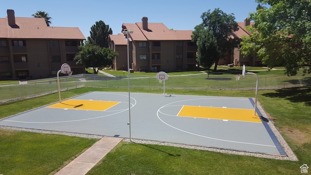 view of basketball court with a yard
