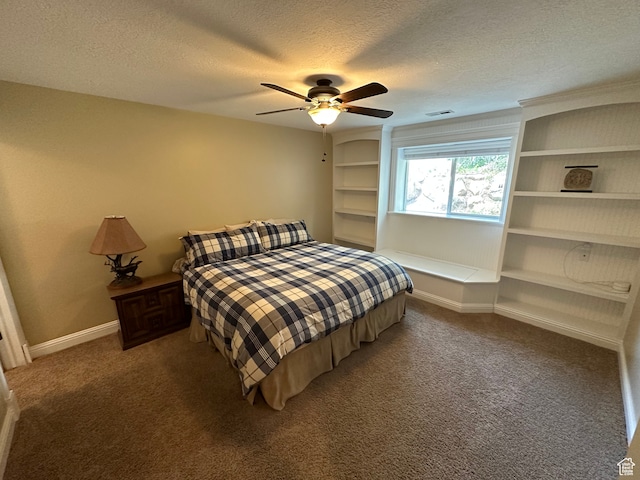 carpeted bedroom featuring visible vents, baseboards, ceiling fan, and a textured ceiling