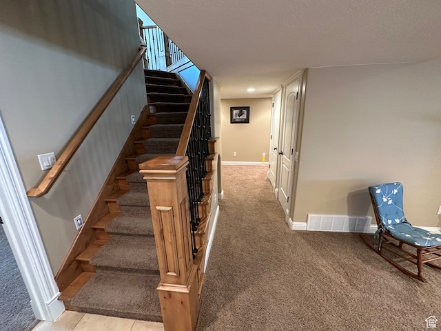 stairs with carpet, baseboards, and visible vents