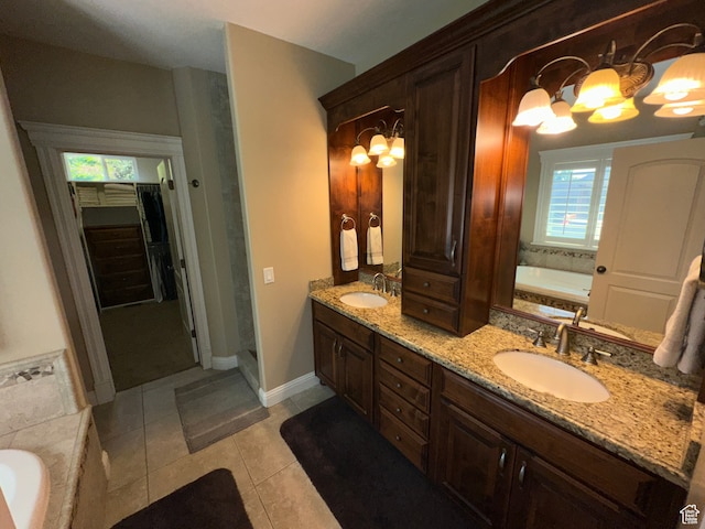 bathroom with double vanity, a sink, tile patterned flooring, and a notable chandelier
