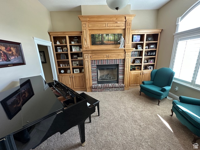 living area featuring baseboards, carpet floors, and a fireplace
