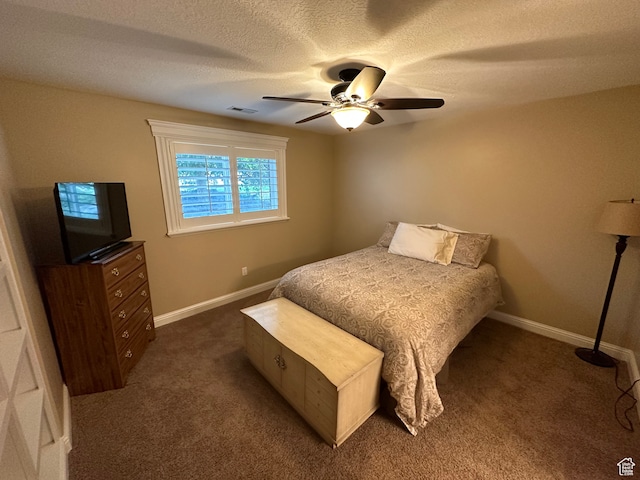 bedroom featuring baseboards, visible vents, dark colored carpet, and a textured ceiling