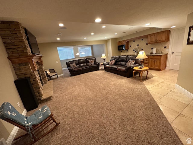 living room featuring light tile patterned floors, baseboards, and recessed lighting